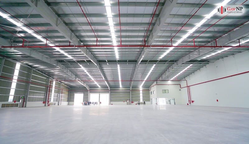 A large warehouse with many windows Description automatically generated